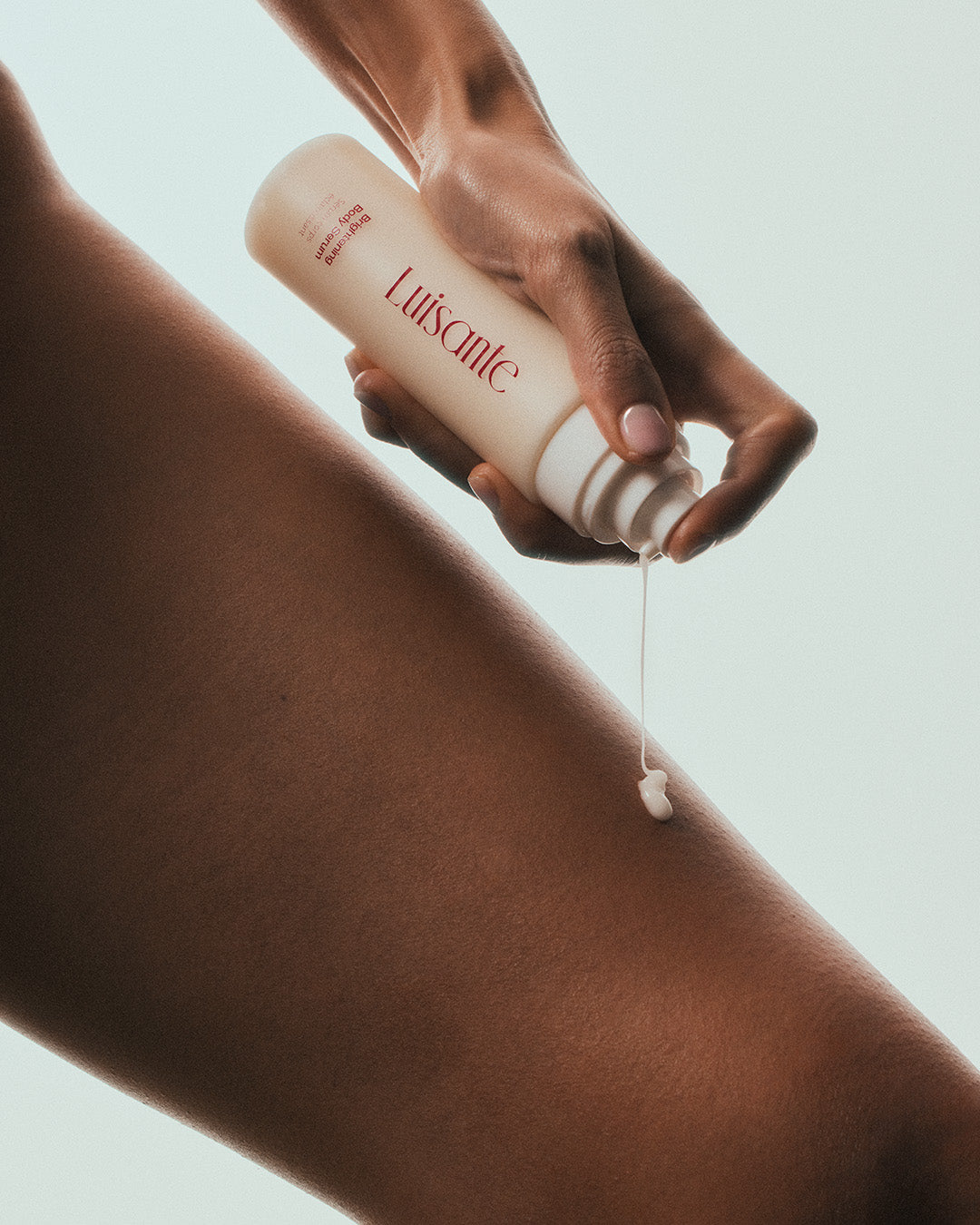Luisante Brightening Body Serum being applied to skin for hydration and nourishment