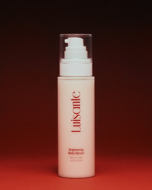 Luisante brightening body serum in a white pump bottle with red logo on a red background
